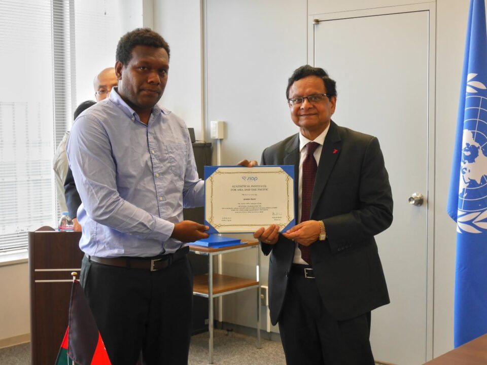 Graeme Risoni receives his certificate of completion from the UN SIAP Director, Ashish Kumar