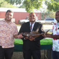 MAL Minister Hon. Franklyn Derek Wasi (centre) and PS Dr. Samson Viulu presenting a thank you gift (crafted sailing fish) to outgoing PS Lottie Vaisekavea.