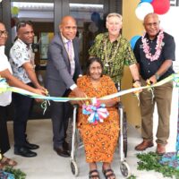 In photo cutting the ribbon infront of the Urban Health Centre (left to right) Dr Anniver Aitorea, Director Naha Birthing and Urban Health Centre, Clement Terewauri, Deputy City Mayor Honiara City Council, Hon. Morris Toiraena, Minister Ministry of Health and Medical Services, Jeff Roach Australia High Commissioner, Dr. Lawrence Diau Director Honiara City Council and sitting infront Ann Seinemua, Community representative Naha 1.