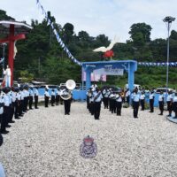 RSIPF officers pay their respects while the police band slow-matches the casket of the late Manele to the Tanagai church.