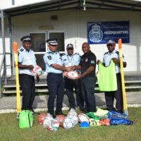 Police commissioner (middle left) handing over sporting equipment’s to Staff Sergeant Stanley Waita of OST (middle right).